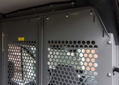 Ford Transit cargo van bulkhead partition with perforated view-through areas.